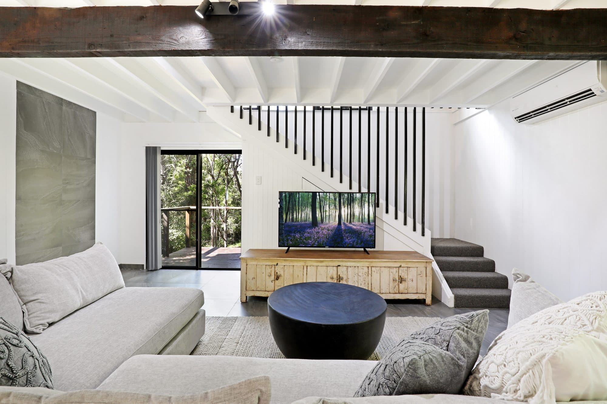 Levante living area with dark timber beams and warm, moody light, Serenity 222