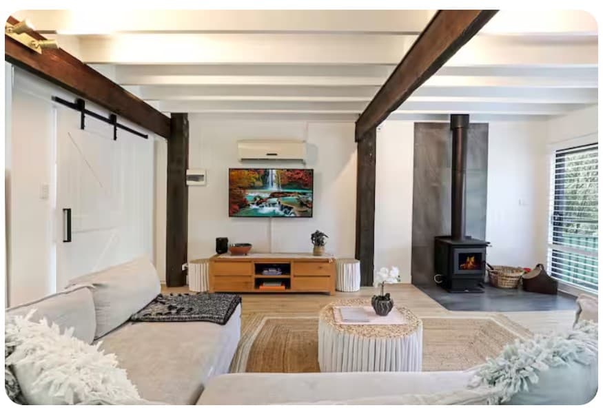Living room at Amalfi, Serenity 222 — light, airy and warmed by the wood fire