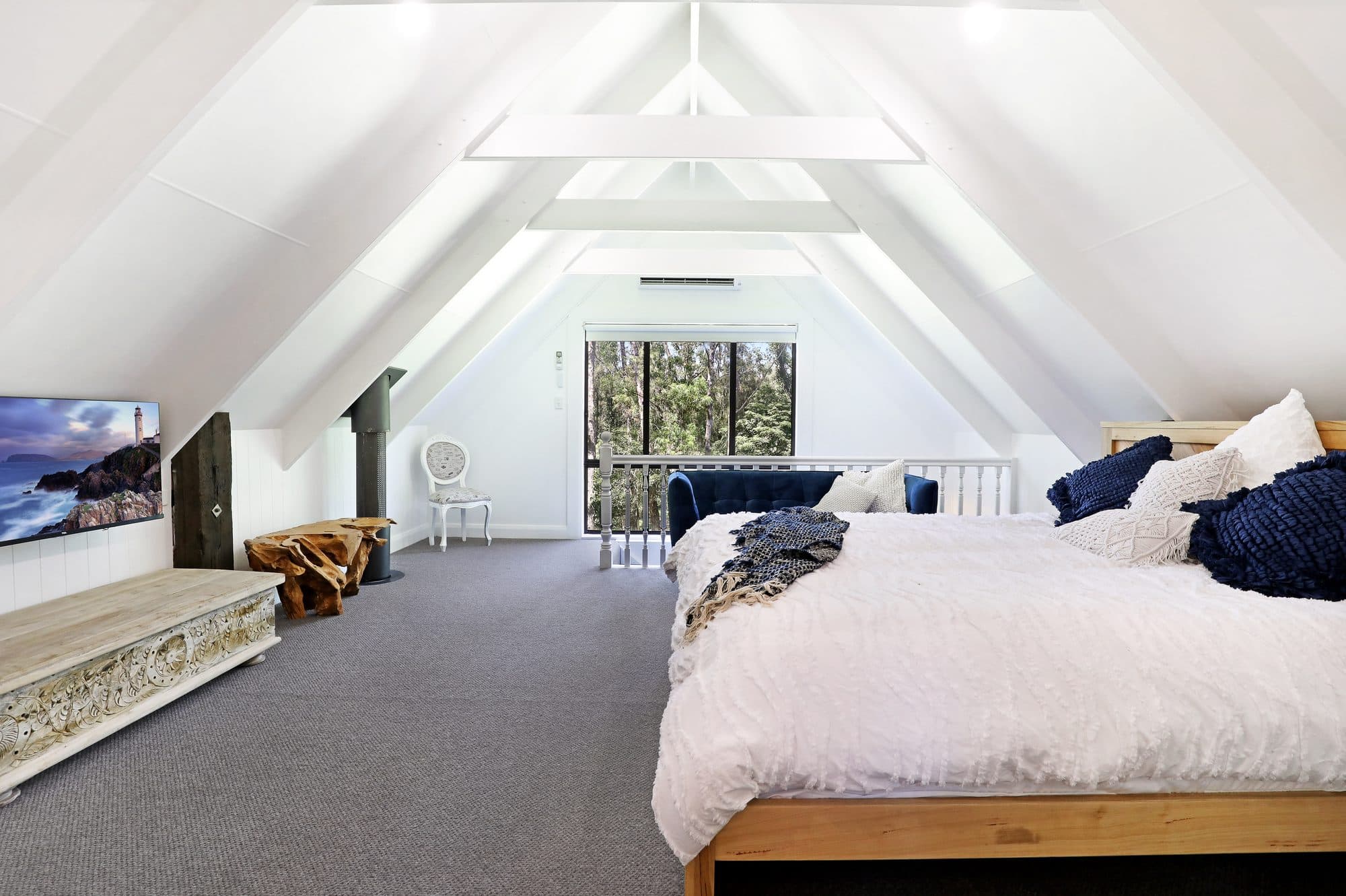 Bedroom at Amalfi, Serenity 222 — soaring white A-frame ceiling among the gum trees