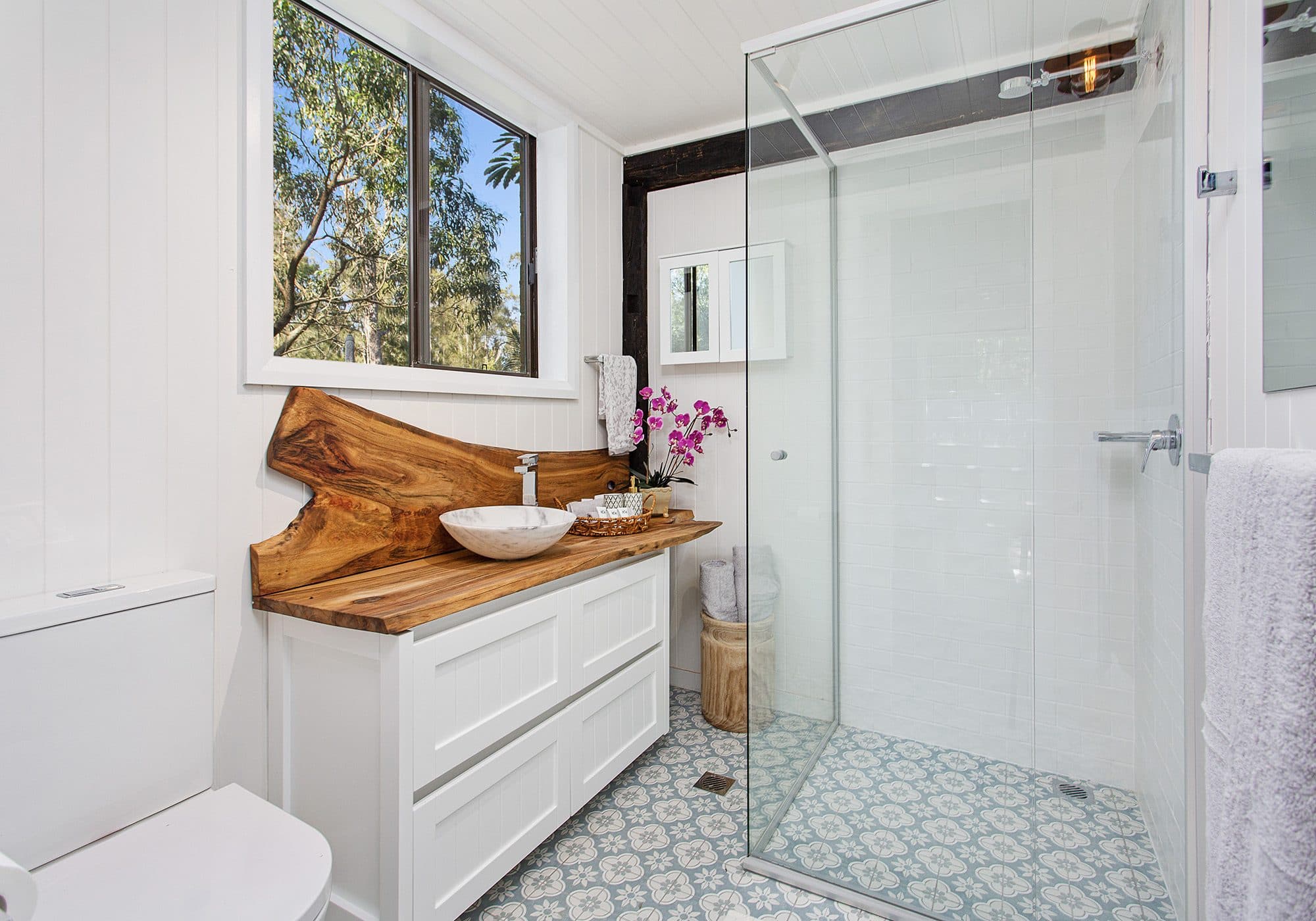Bathroom at The Barn, Serenity 222, with reclaimed timber beam and glass shower