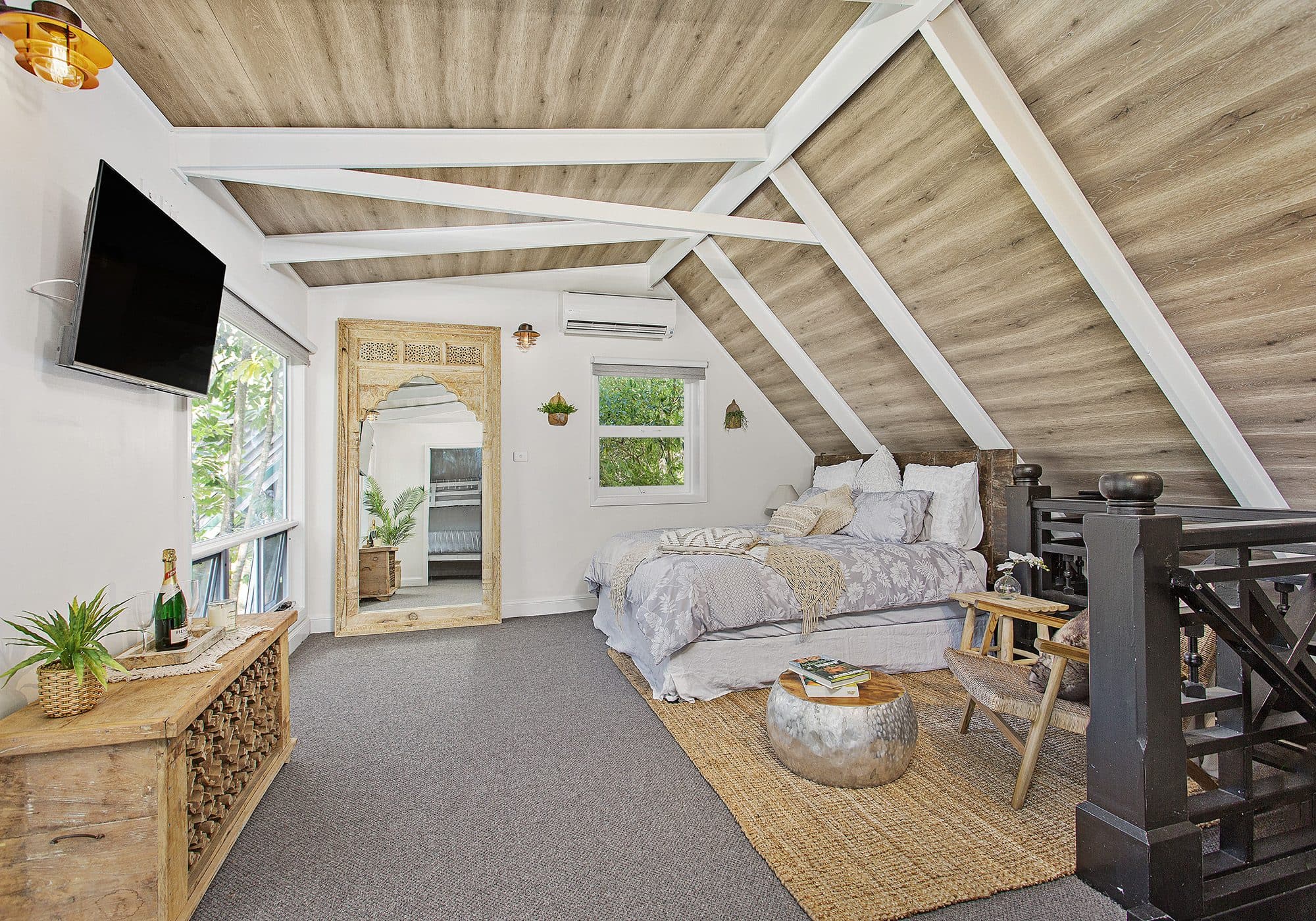 Main bedroom at The Barn, Serenity 222, wide view with loft staircase