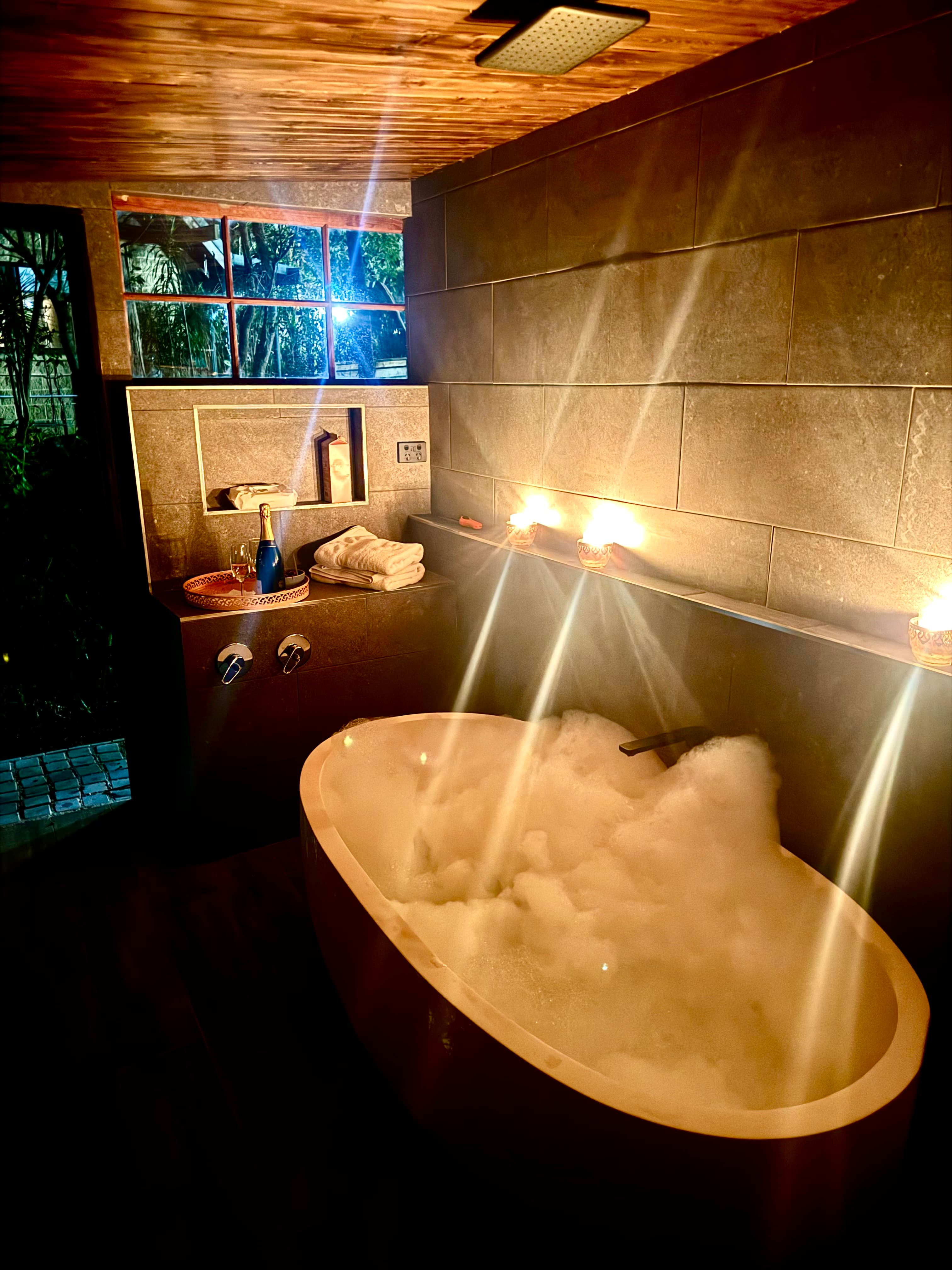 The secret pamper room at The Barn, Serenity 222 — candlelit stone bath with rain shower, exclusive to Barn guests