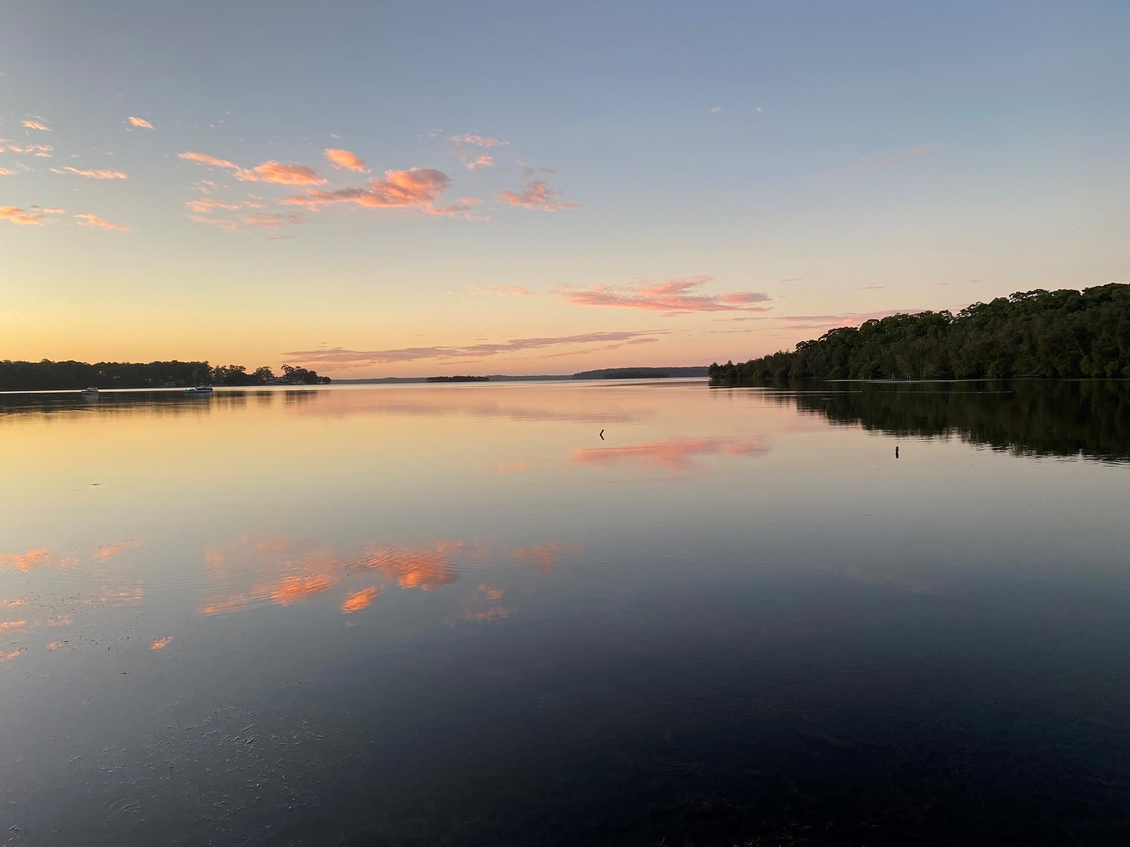 Pink clouds reflected in the still water of St Georges Basin at dusk, Serenity 222