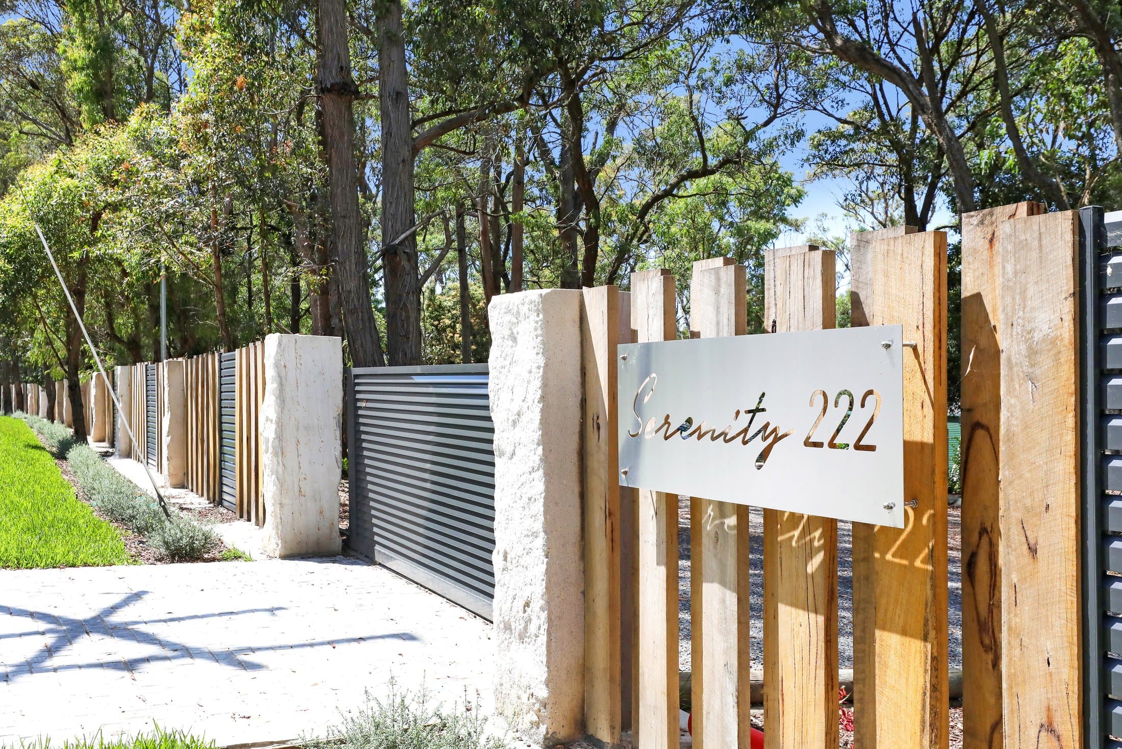 The gated timber-and-stone entrance to Serenity 222, 222 The Wool Road, St Georges Basin